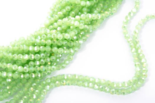 Beautiful Light green Glass Sparkle Crystal Isoalted Beads on white background. Use for diy beaded jewelry