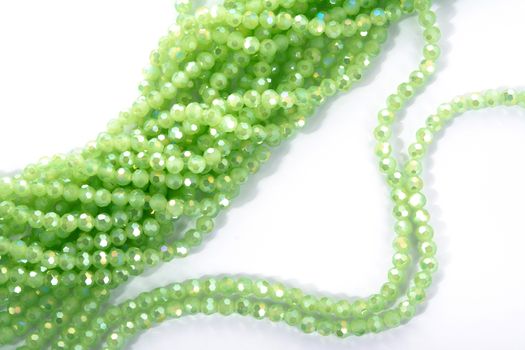 Beautiful Light green Glass Sparkle Crystal Isoalted Beads on white background. Use for diy beaded jewelry