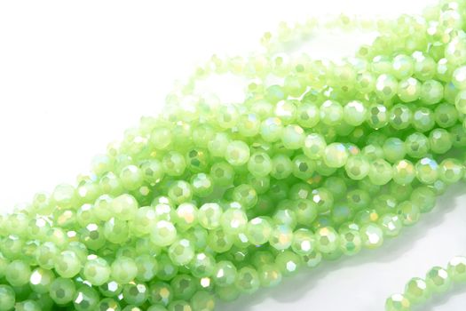 Beautiful Light green Glass Sparkle Crystal Isoalted Beads on white background. Use for diy beaded jewelry