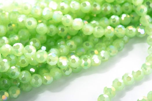 Beautiful Light green Glass Sparkle Crystal Isoalted Beads on white background. Use for diy beaded jewelry