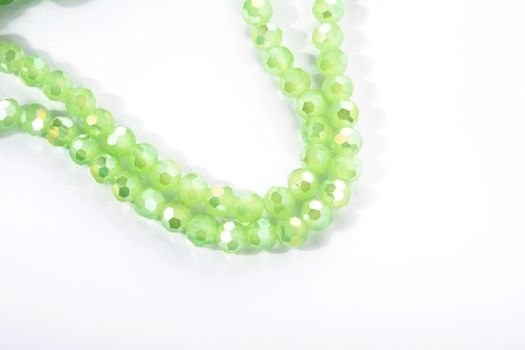 Beautiful Light green Glass Sparkle Crystal Isoalted Beads on white background. Use for diy beaded jewelry