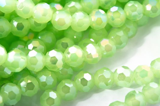 Beautiful Light green Glass Sparkle Crystal Isoalted Beads on white background. Use for diy beaded jewelry