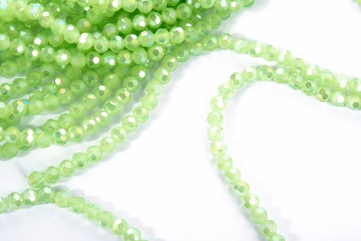 Beautiful Light green Glass Sparkle Crystal Isoalted Beads on white background. Use for diy beaded jewelry