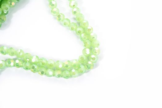 Beautiful Light green Glass Sparkle Crystal Isoalted Beads on white background. Use for diy beaded jewelry