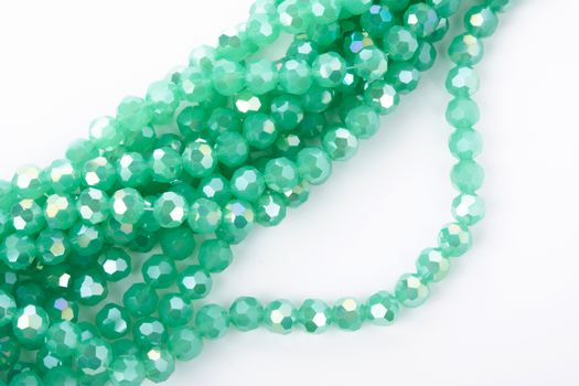 Beautiful Light green Glass Sparkle Crystal Isoalted Beads on white background. Use for diy beaded jewelry