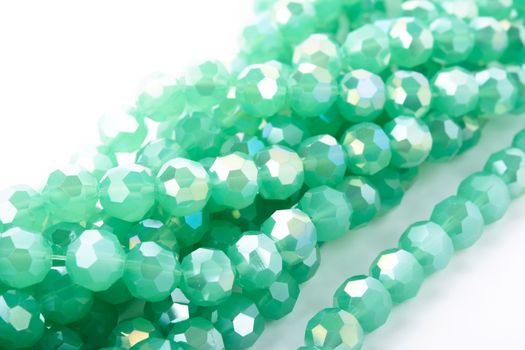 Beautiful Light green Glass Sparkle Crystal Isoalted Beads on white background. Use for diy beaded jewelry