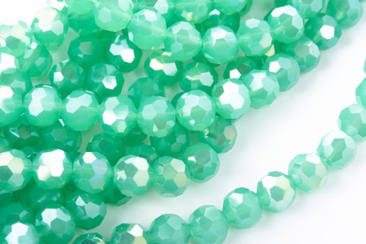 Beautiful Light green Glass Sparkle Crystal Isoalted Beads on white background. Use for diy beaded jewelry