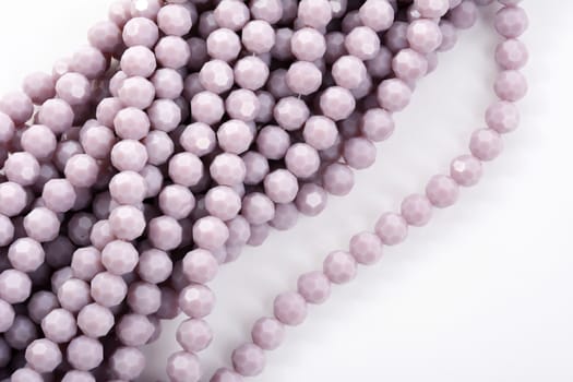 Beautiful Light purple Glass Sparkle Crystal Isoalted Beads on white background. Use for diy beaded jewelry