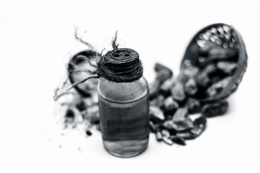 Raw organic dried dates in a hamper with its extracted oil and its powder in a clay bowl isolated on white which widely used in flavored beverages almost entire Asia.