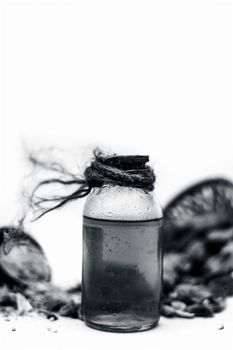 Raw organic dried dates in a hamper with its extracted oil and its powder in a clay bowl isolated on white which widely used in flavored beverages almost entire Asia.