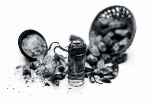 Essential oil of kharek of dried dates or sukhi khajoor or Phoenix dactylifera in a transparent glass bottle isolated on white with raw dried dates and its powder.