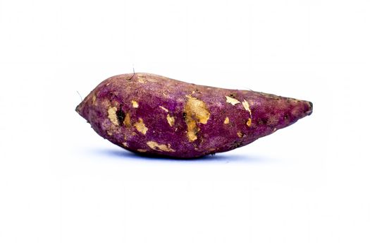Root vegetable isolated on white i.e. Sweet potato or shakarakand or Ipomoea batatas or yam.