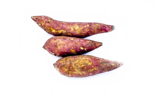 Root vegetable isolated on white i.e. Sweet potato or shakarakand or Ipomoea batatas or yam.