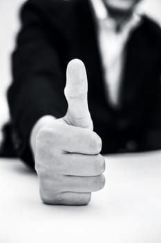 Close up of hand of business man showing thumbs up or showing happiness via hand gesture isolated on white.