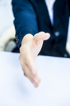 Close up of businessman's hand giving or wanting to hand shake or collaborating concept isolated on white.