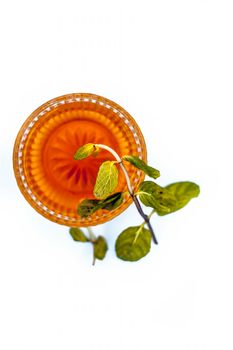 Close up of raw organic honey with some mint leaves isolated on white.;