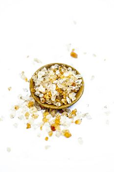 Close up of popular Indian &Asian spices isolated on white in a glass plate i.e. Khatira gond or quatira gond or Indian edible gum or common edible gum or goundh or gound or acacia gum.