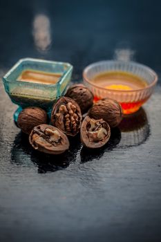 Close up of best home remedy to treat Anemia in a glass bowl on wooden surface consisting of walnut powder and raw organic honey.