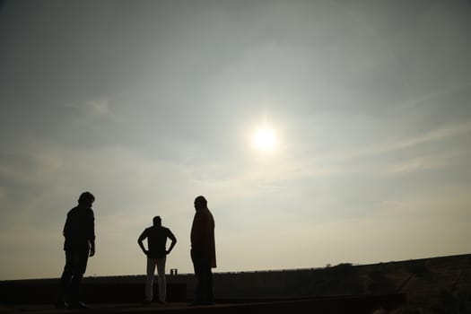 Silhouette of people on hill
