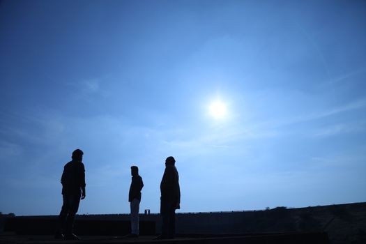 Silhouette of people on hill