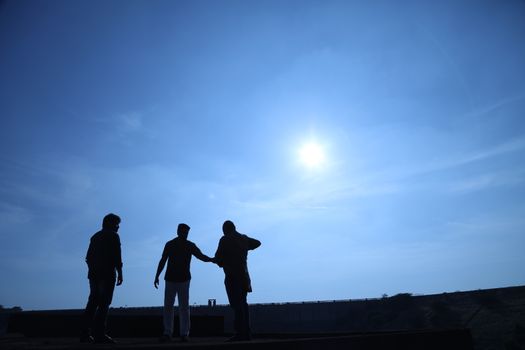 Silhouette of people on hill