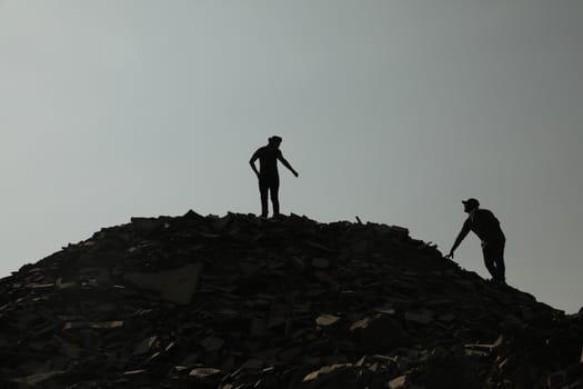 Silhouette of people on hill