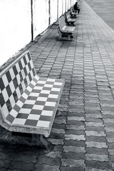 A single human being sitting on the benches in the early morning.Minimalistic shot.