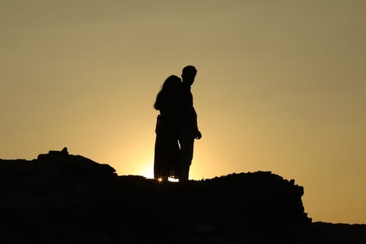 Silhouette of people on hill