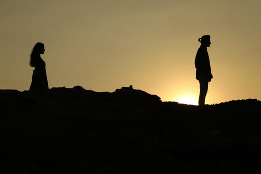 Silhouette of people on hill