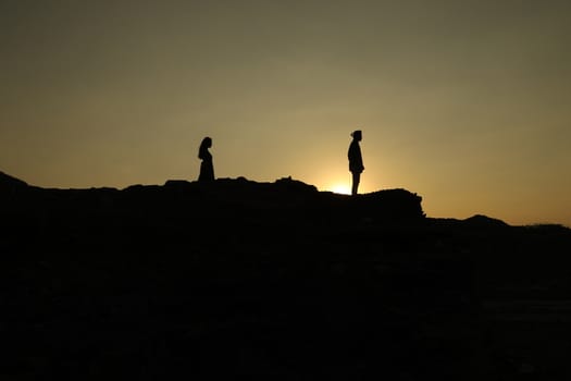 Silhouette of people on hill