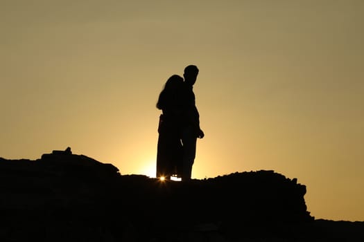 Silhouette of people on hill