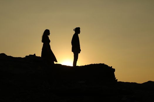 Silhouette of people on hill
