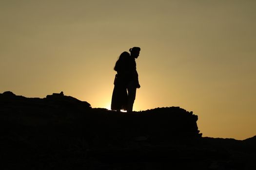 Silhouette of people on hill
