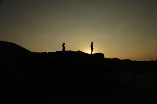 Silhouette of people on hill