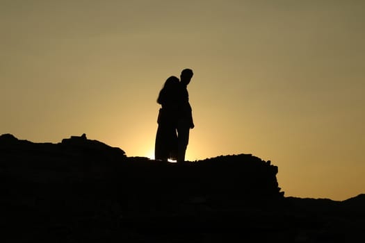 Silhouette of people on hill