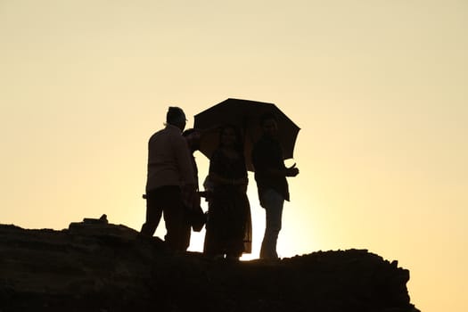 Silhouette of people on hill