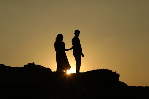 Silhouette of people on hill