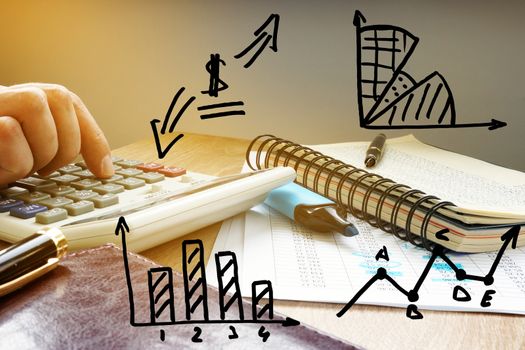 Business accounting. Businessman calculating financial figures. Charts and graphs.