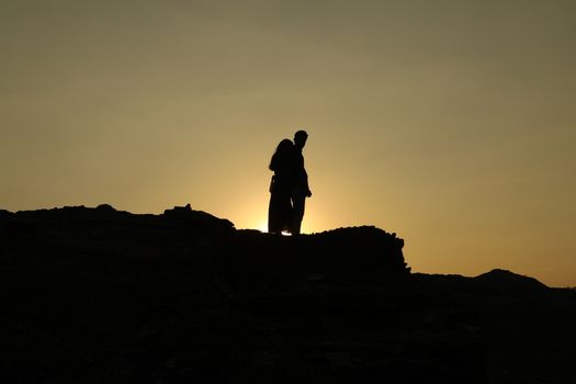 Silhouette of people on hill