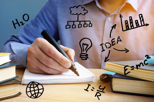 Education concept. Man writing in the notepad.