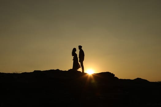 Silhouette of people on hill