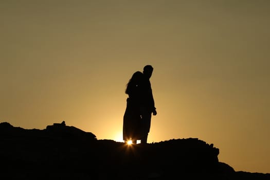 Silhouette of people on hill