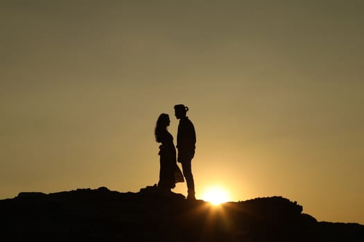 Silhouette of people on hill