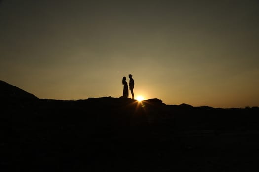 Silhouette of people on hill