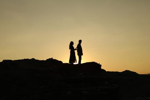 Silhouette of people on hill