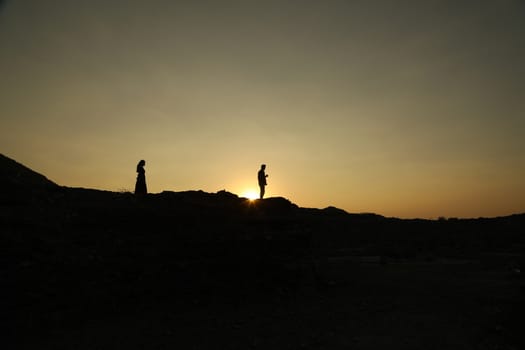 Silhouette of people on hill