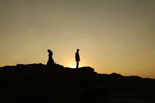 Silhouette of people on hill