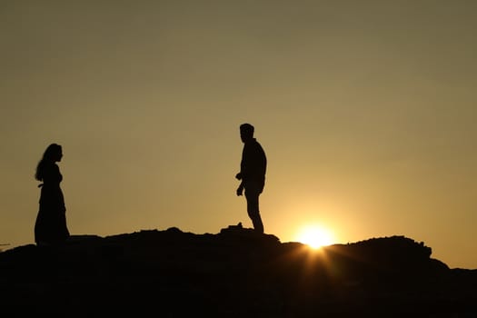 Silhouette of people on hill