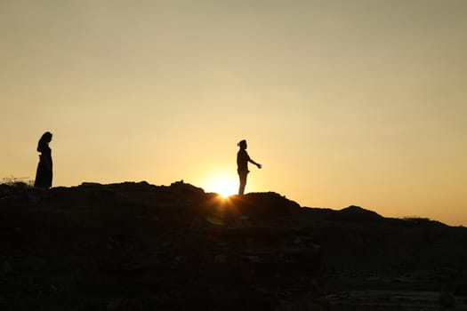 Silhouette of people on hill
