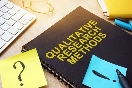 Qualitative research methods and sticks on a desk.